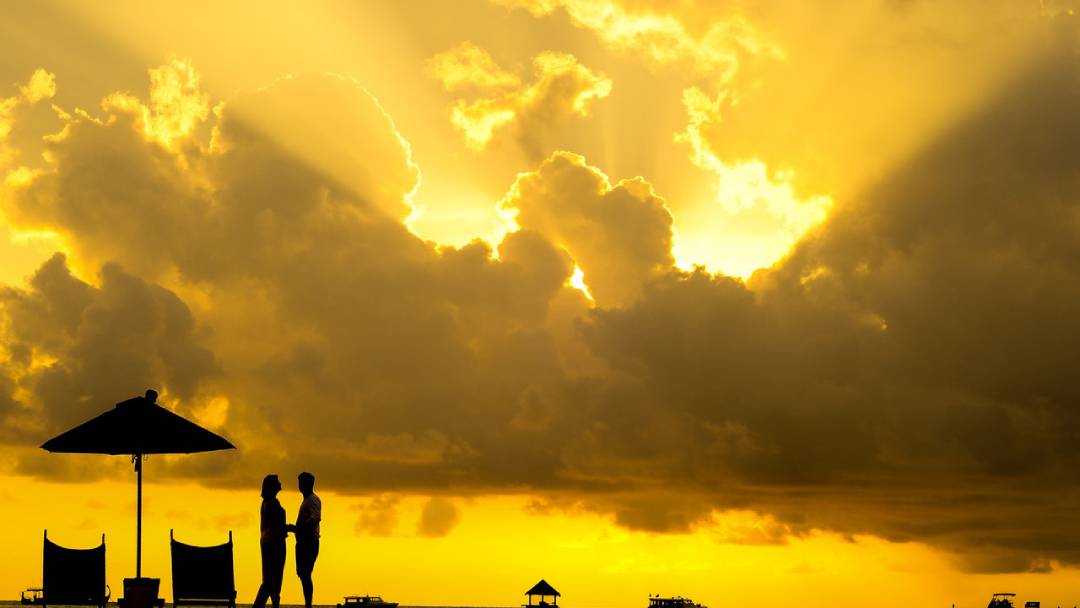 silhouette-photo-of-man-and-woman-beside-body-of-water